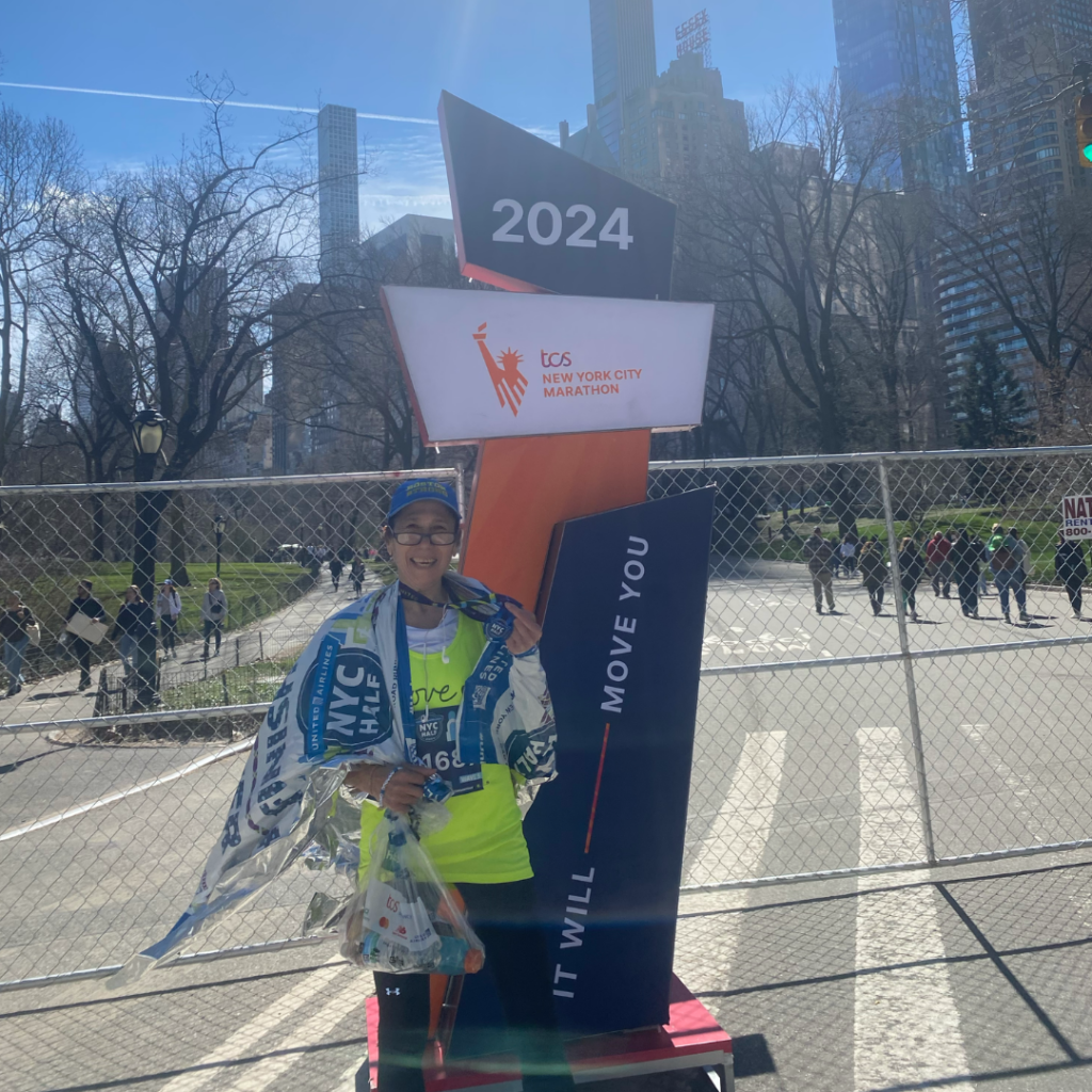 Tara, a craniopharyngioma survivor, crosses the finish line at the United Airlines NYC Half Marathon
